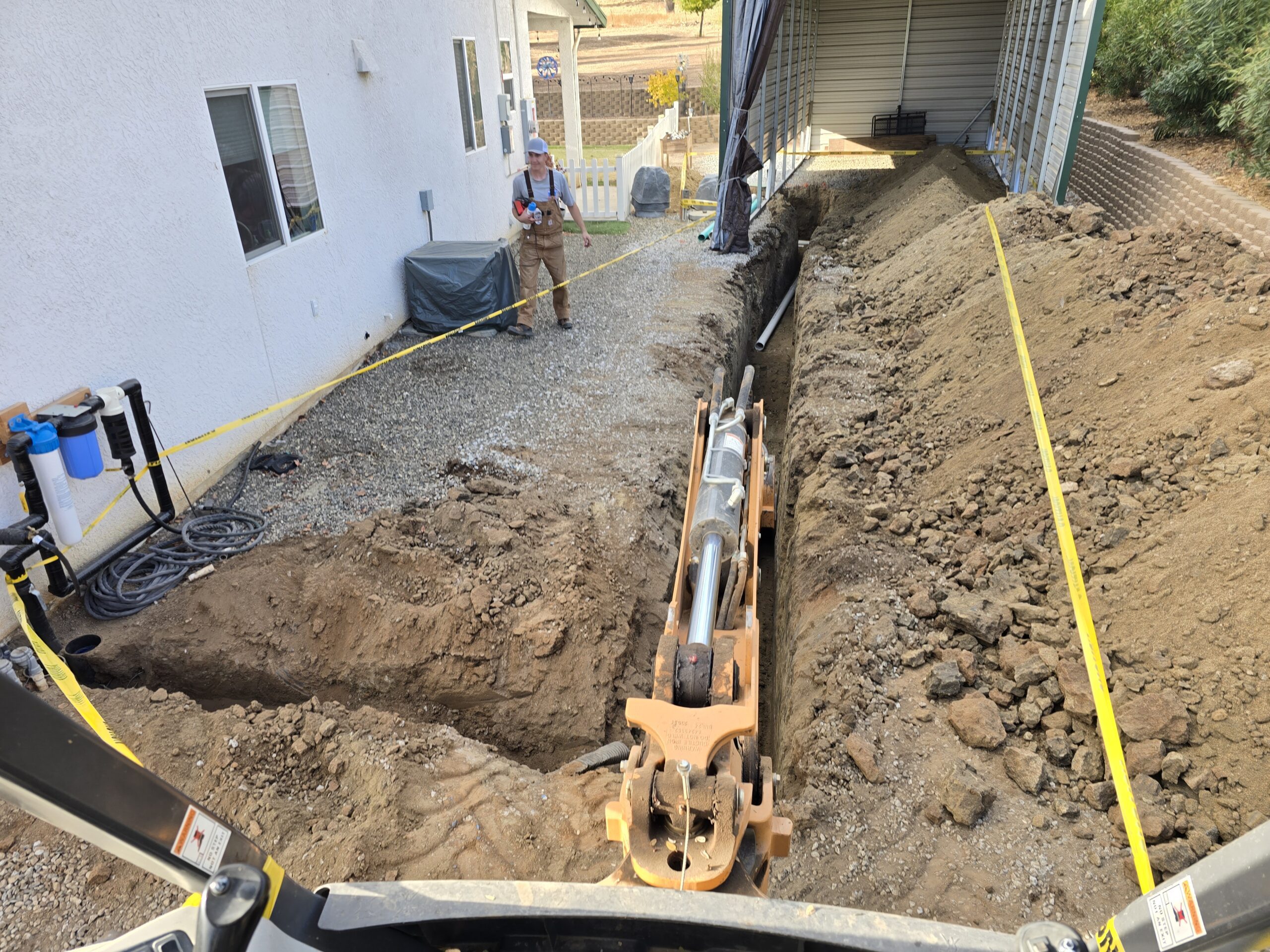 Close-up of RV valves and rock leach line addition, showing the detailed installation of valves and rock-filled drainage lines