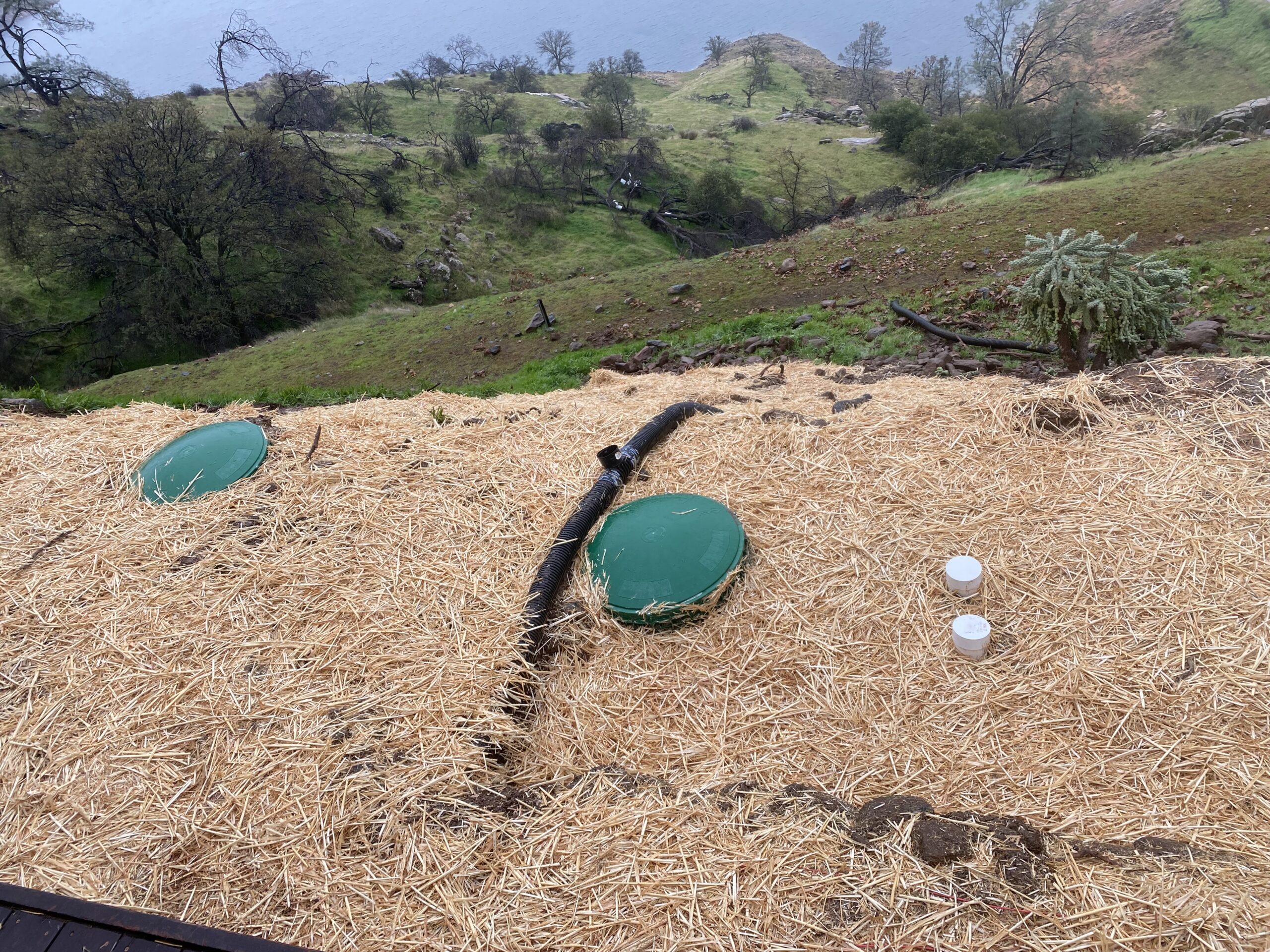 New tank installation, showing the newly placed tank and connection to plumbing or septic system